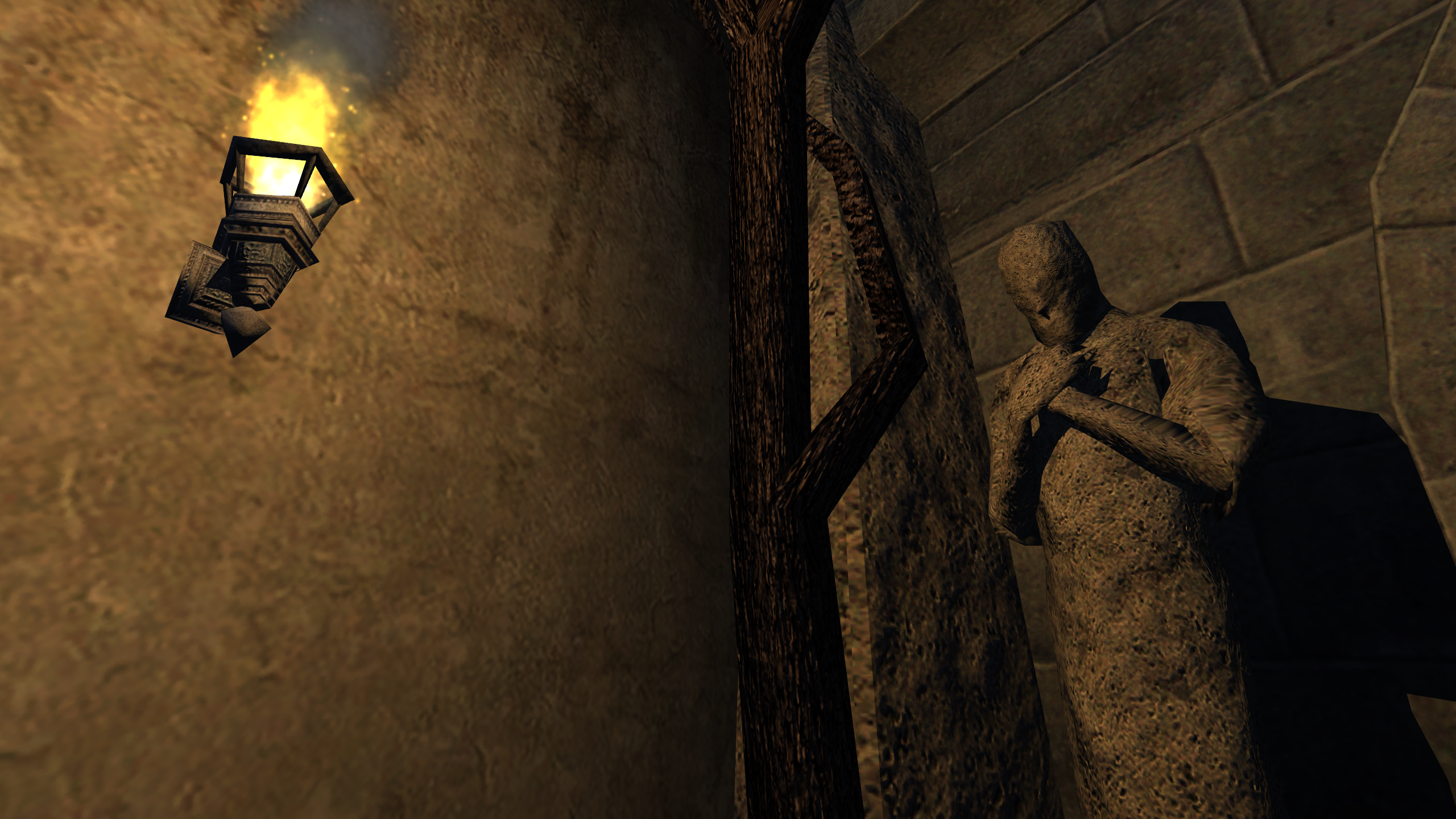 A statue, lit by torchlight