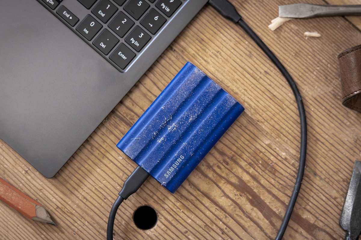 1732919405 843 Portable SSDs arent just for backups Heres why everyone needs Samsung T7 Shield portable SSD lifestyle shot on wooden table